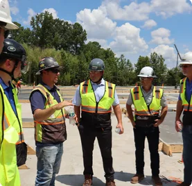 Bobbitt project team reviewing a job site in hi-vis and hard hats
